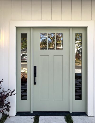 The front door of a home is painted green.