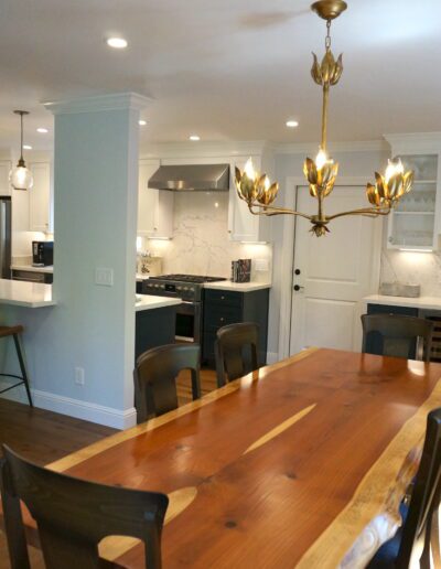 A kitchen with a wooden table and chairs.