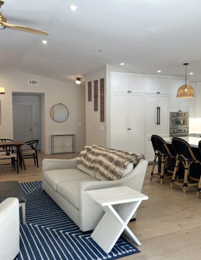 A living room, dining room and kitchen in a home.